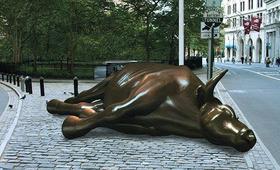 Una imagen tratada con Photoshop que muestra al famoso toro de Wall Street en el suelo, para ejemplificar el colapso de los mercados financieros