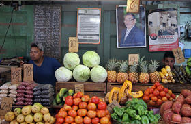 Dos jóvenes esperan la llegada de clientes en un agromercado en La Habana, en esta foto de archivo