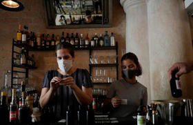 Diana Figueroa prepara tragos para llevar, en su restaurante de La Habana, en medio de la pandemia de coronavirus