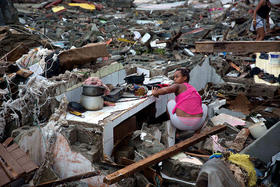 Una mujer busca entre las ruinas de su vivienda destruida por el huracán Matthew en Baracoa, Cuba