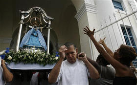 Devotos de la Virgen de Regla trasladan su imagen durante una procesión en su honor. (AP)