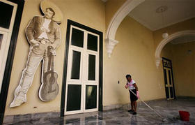 Una habanera limpia el piso en la Casa Benito Juárez, durante el Día Internacional de la Mujer