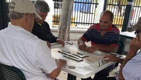 Cubanos jugando al dominó en la plaza Máximo Gómez en Little Habana, Miami el 31 de octubre de 2016